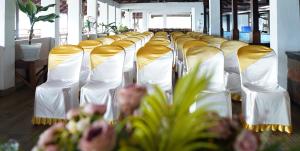 a row of white and gold chairs with flowers at Cherai Beach View Heritage in Cherai Beach +61 photos