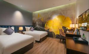 a hotel room with two beds and a mural at Ryan Barnett home in Puerto Deseado