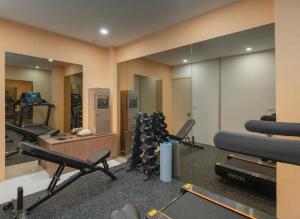 a gym with a bunch of exercise equipment and mirrors at Ryan Barnett home in Puerto Deseado