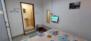 a bathroom with a sink and a television on a wall at LA MOTEL in Sungai Petani