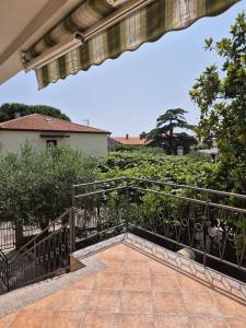 a balcony with a iron railing and a garden at Norma 3 in Novigrad Istria