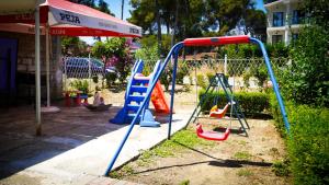 a playground with a slide and a swing at Vila Flamuri in Golem