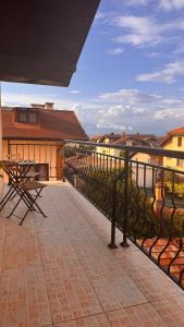 a balcony with a table and chairs on a building at Dima Suites Bansko - Vihren view & free parking in Bansko +56 photos