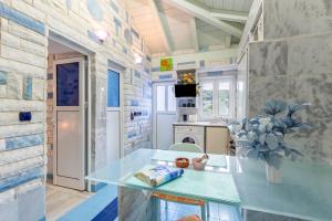 a kitchen with a glass counter in a room at Paco's Resort Standard Studio 3 in Oziás
