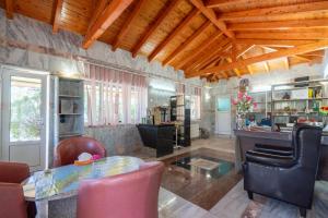 a living room with a table and some chairs at Paco's Resort Standard Studio 1 in Oziás