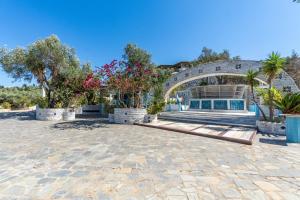 a home with a stone patio and an archway at Paco's Resort Standard Studio 3 in Oziás