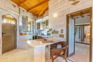 a kitchen with a table and chairs in a room at Paco's Resort Luxury Villa 19 in Oziás