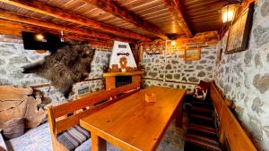 a wooden bench in a room with a wooden table at Dima Suites Bansko - Vihren view & free parking in Bansko