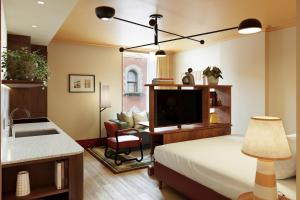 a bedroom with a bed and a sink and a television at The July - Capel Street in Dublin