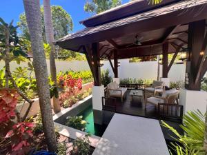 an outdoor patio with a wooden pergola at Villa Mirada Maenam - Renovated Four Bedroom with Private Pool in Nathon Bay