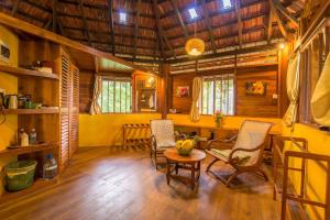 a room with chairs and a table in a house at Palm Paradise Cabanas & Villas Beach Resort in Tangalle