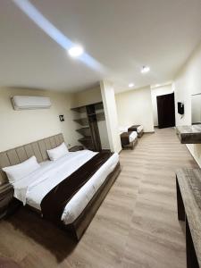 a bedroom with a large bed in a room at Selena Hotel Aqaba in Aqaba