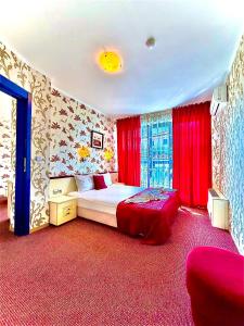 a bedroom with a bed and red drapes at Boutique Hotel Royal in Nesebar +60 photos