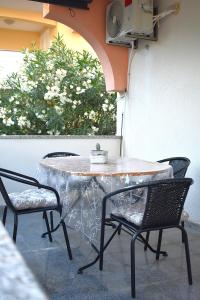 a table with two chairs and a table with a cactus on it at Apartmani Benedetti in Povljana +57 photos