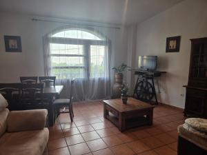a living room with a couch and a table at El Secreto de Boada Spa privado & Restaurante Adults Only in Villamiel