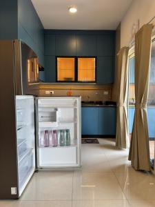 a refrigerator with its door open in a kitchen at Sky height 2BHK in GIFT CITY in Gandhinagar