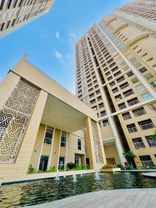 a building in front of a tall building at Sky height 2BHK in GIFT CITY in Gandhinagar