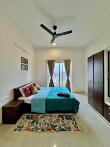 a bedroom with a bed and a ceiling fan at Sky height 2BHK in GIFT CITY in Gandhinagar +67 photos