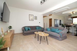 a living room with a couch and a table at Villa After Set Heaven in Čapljina