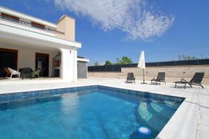 a swimming pool with chairs and a house at Villa After Set Heaven in Čapljina +61 photos