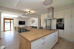 a kitchen with a wooden counter top in a room at Villa After Set Heaven in Čapljina