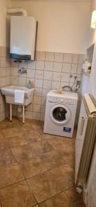 a kitchen with a washing machine and a sink at La Corte di mezzo in Corigliano dʼOtranto