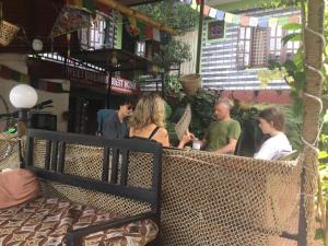 a group of people sitting outside of a restaurant at Sweet Dreams Guest house in Pokhara