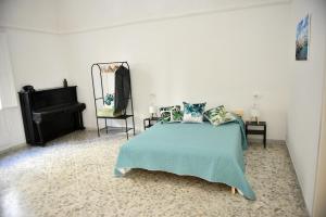 a bedroom with a bed and a piano at Donna Lina Home- Enjoy Apulia in Monopoli