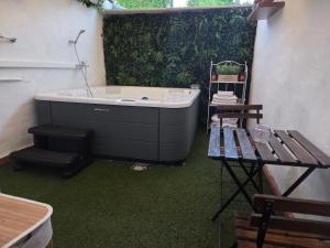 a bathroom with a bath tub and a table at El Secreto de Boada Spa privado & Restaurante Adults Only in Villamiel +24 photos