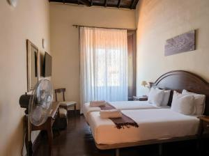 a hotel room with two beds and a fan at Tamahuche Hotel Rural in Vallehermoso