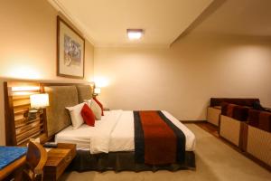 Ένα ή περισσότερα κρεβάτια σε δωμάτιο στο Atithi Resort & Spa