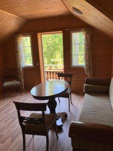 a living room with a table and a couch at Villa SULKAVANRANTA in Sulkava