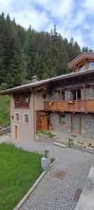a large house with a patio in front of it at B&B Borgo Saint-Rhémy in Saint-Rhémy-en-bosses