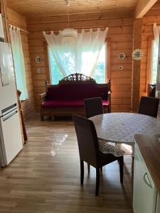a kitchen with a table and a piano in a room at Villa SULKAVANRANTA in Sulkava +11 photos