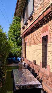 a bench sitting outside of a brick building at Stellwerk Lörrach in Lörrach