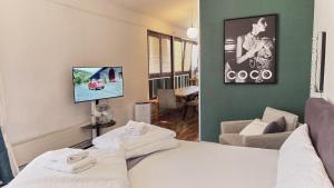 a room with a bed and a couch and a tv at Stellwerk Lörrach in Lörrach
