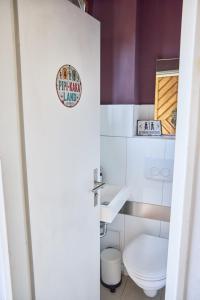 a bathroom with a toilet and a sign on the door at Stellwerk Lörrach in Lörrach