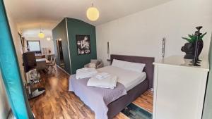a bedroom with a bed with towels on it at Stellwerk Lörrach in Lörrach +70 photos