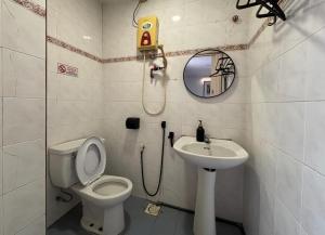 a bathroom with a toilet and a sink at Wangsa Village Inn in Ulu Tiram +28 photos