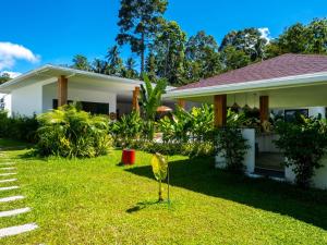 a house with a lawn in front of it at Enchanting Villa Namaste 3Br Private Pool & Garden in Nathon Bay