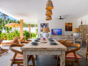 a dining room with a table and chairs at Enchanting Villa Namaste 3Br Private Pool & Garden in Nathon Bay