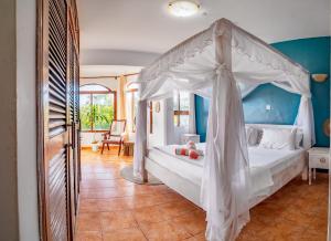 a bedroom with a bed with a canopy at Hewani a bright & airy 1 BR apartment with an ocean view & pool in Kilifi +25 photos