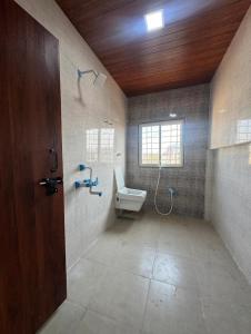 a bathroom with a toilet and a sink and a shower at Atithi Lodging in Ale