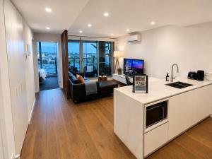 a kitchen and living room with a view of a city at Rise to the top! in Melbourne