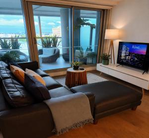 a living room with a couch and a flat screen tv at Rise to the top! in Melbourne