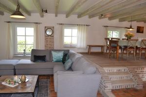 a living room with a couch and a table at Bellefleur in Veurne
