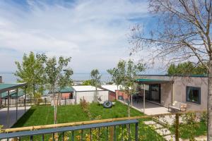 a house with a view of a yard at EUROCAMPINGPACENGO in Lazise