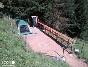 a tent on the side of a hill with a bridge at Tente tout confort in Sarrancolin