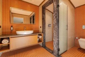 an orange tiled bathroom with a sink and a toilet at Beach 222 Oludeniz in Oludeniz +66 photos