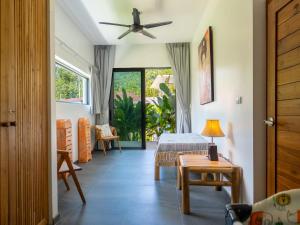 a room with a bed and a table and a window at Enchanting Villa Namaste 3Br Private Pool & Garden in Nathon Bay +50 photos